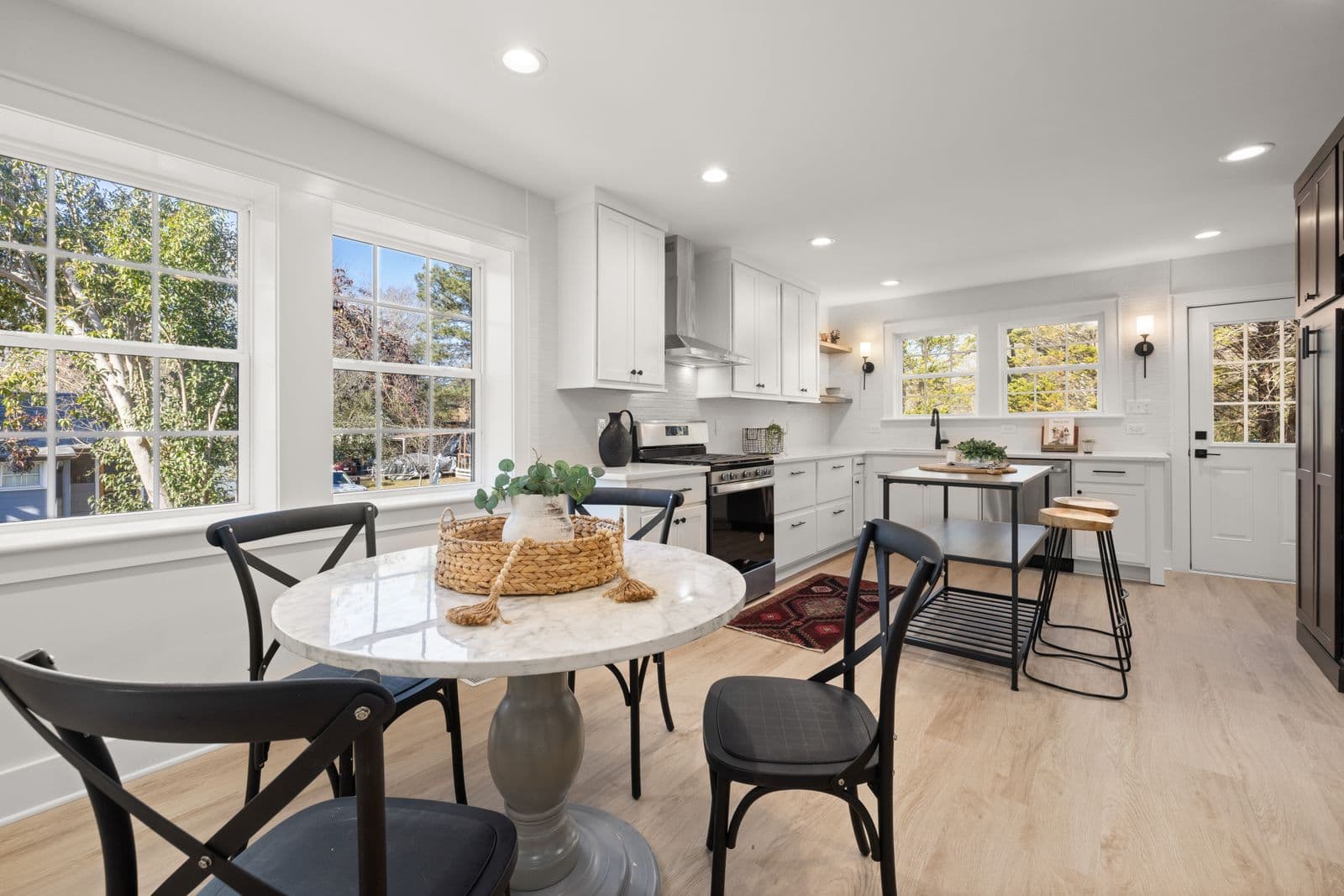 A bright kitchen with white cabinets and natural light. Illustration, not a client’s kitchen.