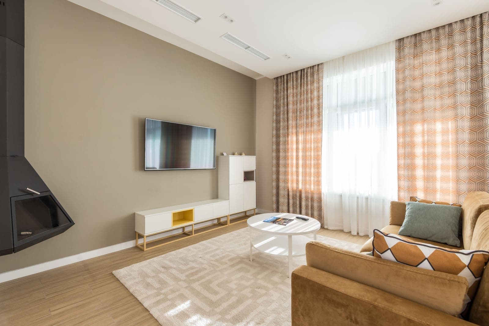 A bright living room with a sofa and natural light from a window. The kind of room a visit walks through. Not a client’s house.